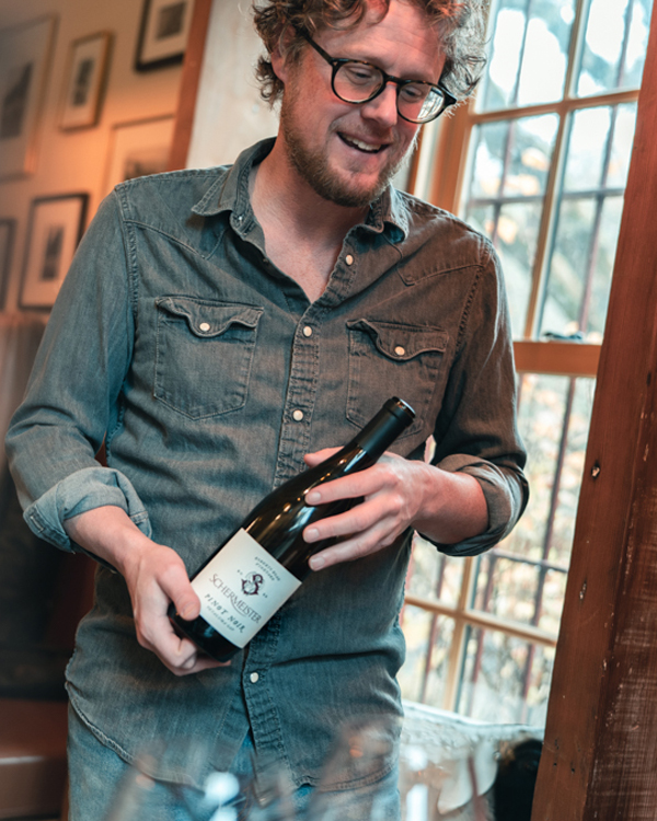 Winemaker Robert Schermeister with bottle of Pinot Noir